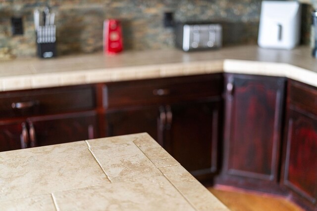 82 Willow Ln, Waynesboro, VA 22980 - detailed view of light countertops, reddish brown cabinets, and decorative backsplash