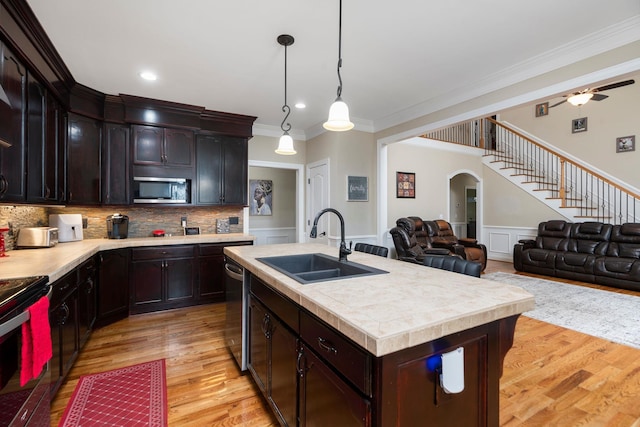 82 Willow Ln, Waynesboro, VA 22980 - kitchen featuring ornamental molding, appliances with stainless steel finishes, a sink, light countertops, and arched walkways