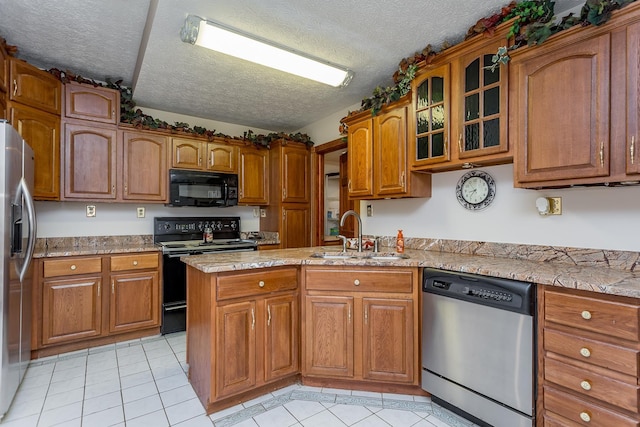 2226 Lanier Ln, Mcgaheysville, VA 22840 - kitchen featuring black appliances, brown cabinets, light tile patterned floors, a textured ceiling, and glass insert cabinets