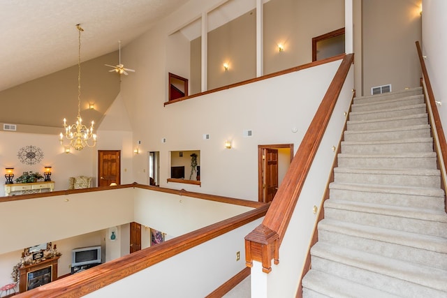 2226 Lanier Ln, Mcgaheysville, VA 22840 - stairway with a ceiling fan, a chandelier, and high vaulted ceiling