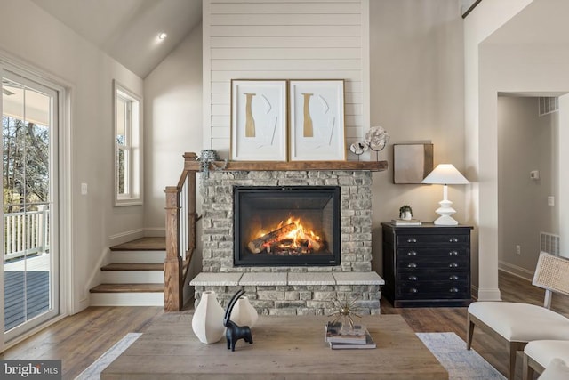 7039 Silk, Jeffersonton, VA 22724 - sitting room featuring baseboards, wood finished floors, lofted ceiling, a fireplace, and stairway