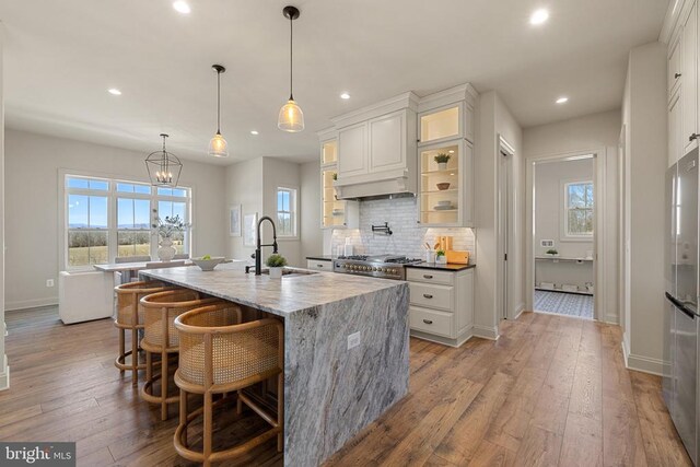 7039 Silk, Jeffersonton, VA 22724 - kitchen with a sink, recessed lighting, freestanding refrigerator, a center island with sink, and decorative backsplash
