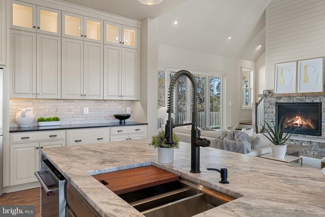 7039 Silk, Jeffersonton, VA 22724 - kitchen with a sink, open floor plan, dark stone counters, decorative backsplash, and dark wood-style flooring