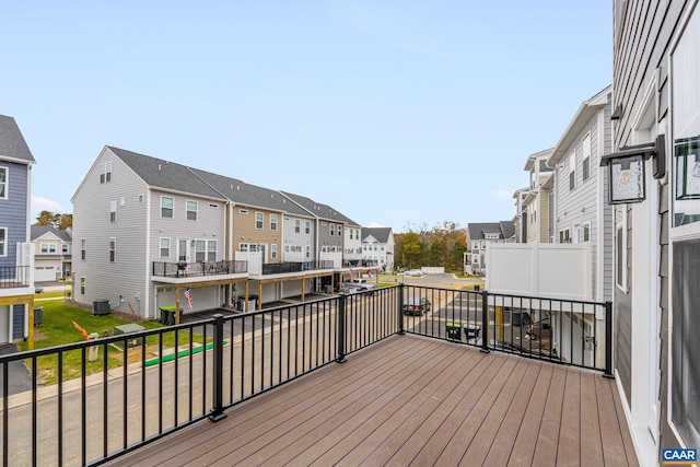 wooden terrace featuring central AC and a residential view