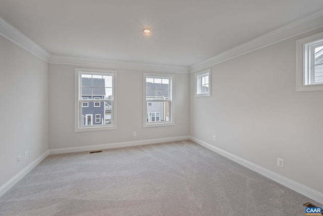unfurnished room with light carpet, baseboards, visible vents, and ornamental molding