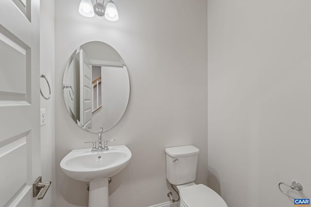 half bath with toilet and a sink