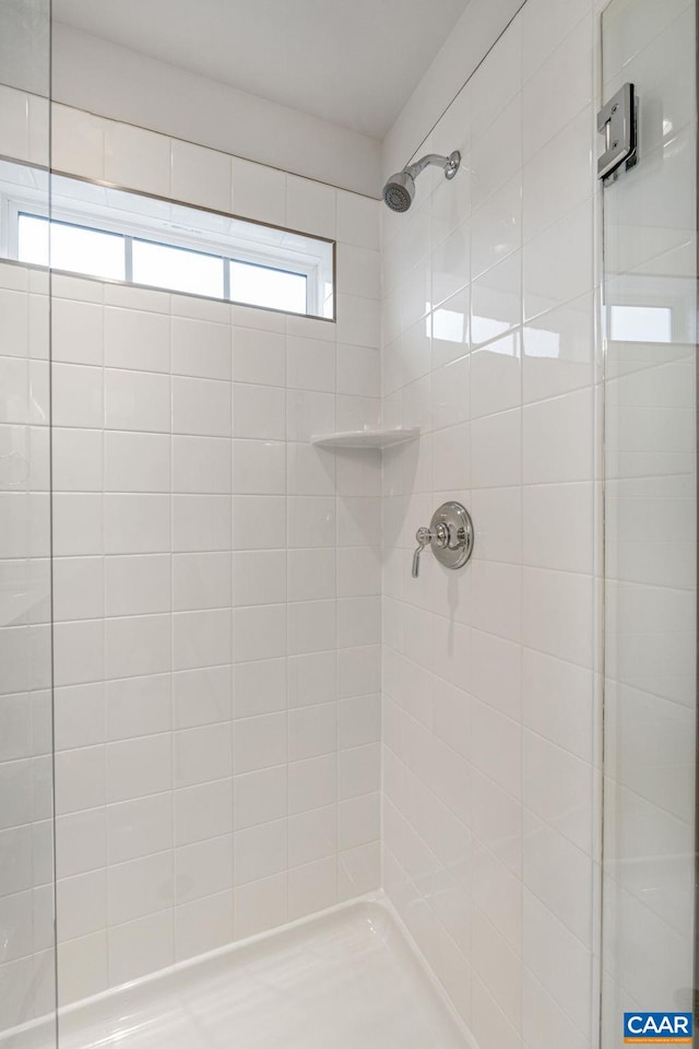 bathroom with tiled shower