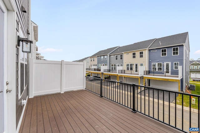 wooden deck with cooling unit and a residential view