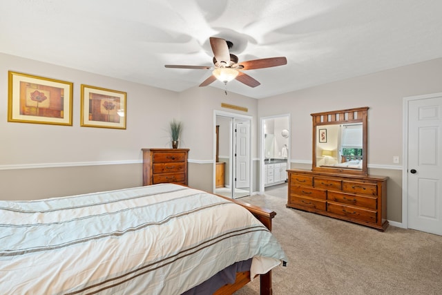 carpeted bedroom with connected bathroom and ceiling fan