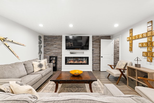 living area featuring wood finished floors, recessed lighting, and a fireplace