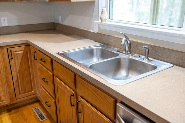kitchen featuring a sink and brown cabinetry