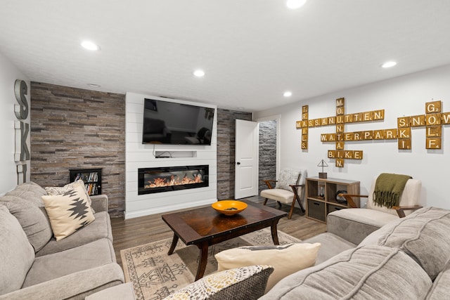 living area with a fireplace, recessed lighting, and wood finished floors