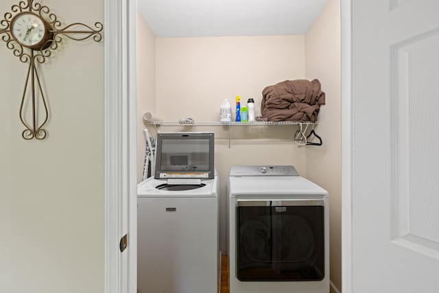 laundry room featuring washing machine and clothes dryer