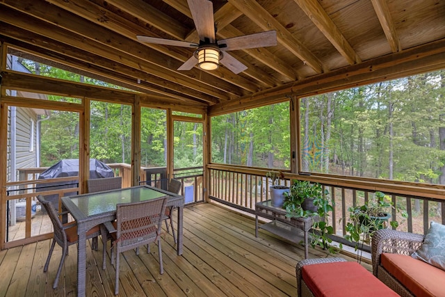 sunroom / solarium with a ceiling fan and outdoor dining area
