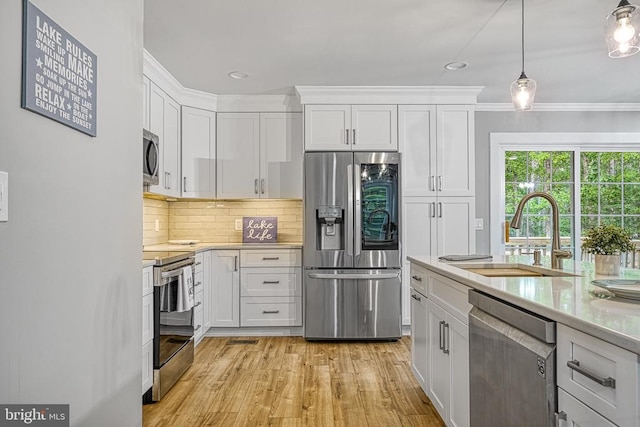 343 Aspen Hill Rd, Mineral, VA 23117 - kitchen featuring appliances with stainless steel finishes, a sink, light countertops, white cabinetry, and crown molding