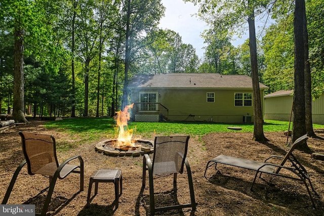 343 Aspen Hill Rd, Mineral, VA 23117 - rear view of house featuring a fire pit, a lawn, central AC unit, and crawl space