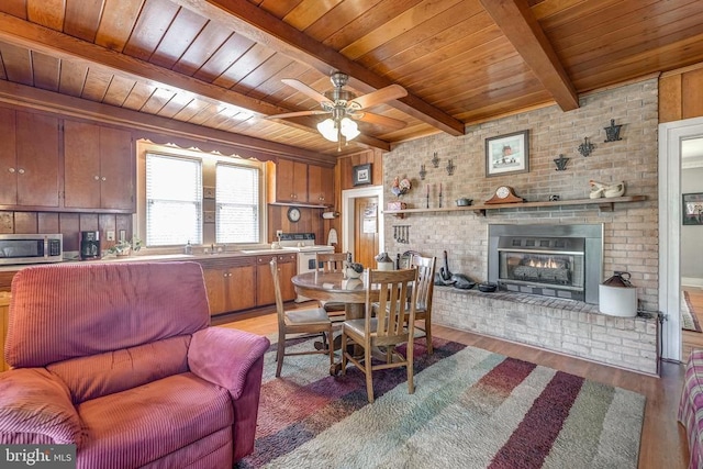 202 Cutler Ave, Louisa, VA 23093 - dining space with wood ceiling, wood finished floors, a fireplace, beamed ceiling, and a ceiling fan