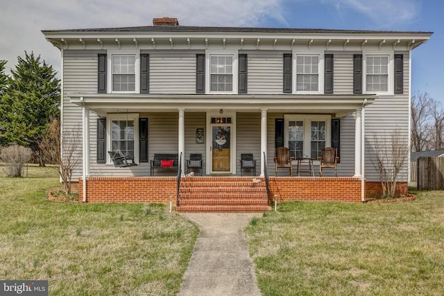 202 Cutler Ave, Louisa, VA 23093 - italianate home with a chimney, a front lawn, and covered porch