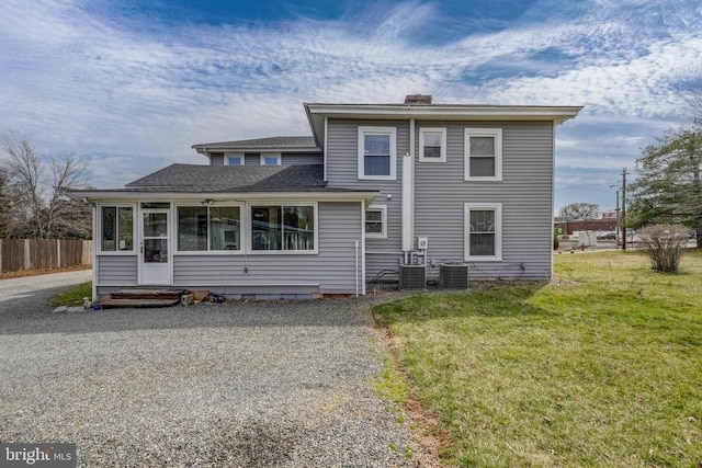 202 Cutler Ave, Louisa, VA 23093 - rear view of house featuring a sunroom, a chimney, central air condition unit, and a shingled roof