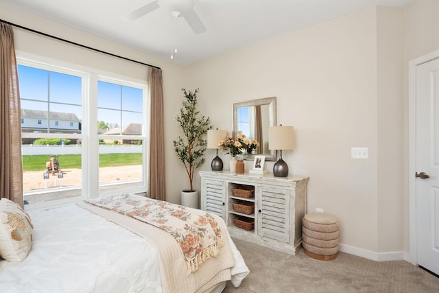 carpeted bedroom with a ceiling fan and baseboards