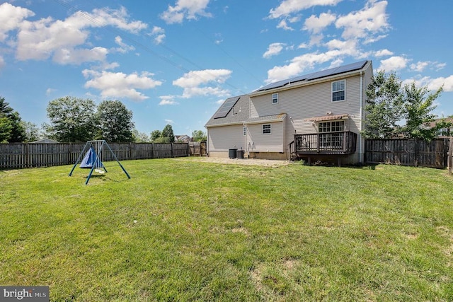 7504 Heathrow Dr, Fredericksburg, VA 22407 - back of property with a deck, roof mounted solar panels, and central AC