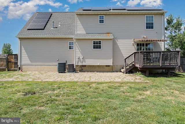7504 Heathrow Dr, Fredericksburg, VA 22407 - back of property featuring roof mounted solar panels, a patio, a wooden deck, and central air condition unit