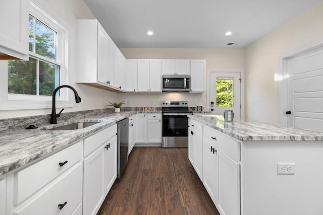 1019 Frye St, Waynesboro, VA 22980 - kitchen featuring stainless steel appliances, a kitchen island, white cabinets, dark wood-style flooring, and light stone countertops