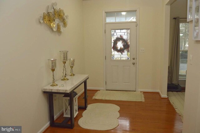 entryway with wood finished floors and baseboards