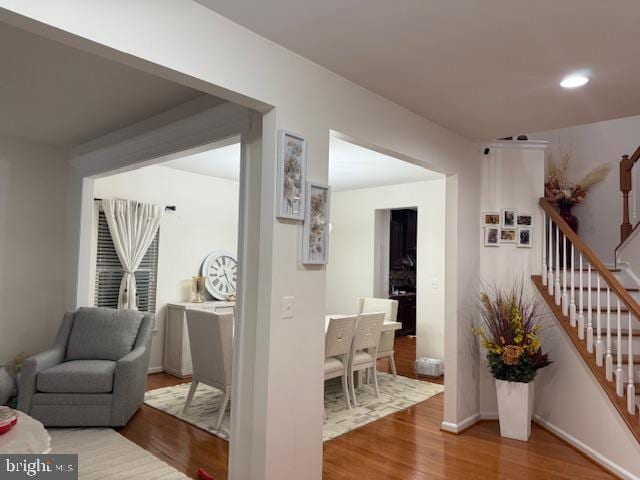 hall featuring stairway, wood finished floors, and recessed lighting