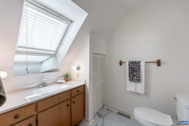 bathroom with toilet, marble finish floor, visible vents, vanity, and vaulted ceiling