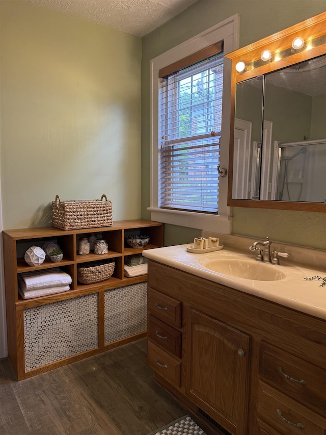 228 Hendren Ave, Staunton, VA 24401 - full bathroom with wood finished floors, vanity, and a textured ceiling
