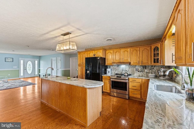 1066 Honeyville Rd, Stanley, VA 22851 - kitchen featuring stainless steel range oven, black refrigerator with ice dispenser, a sink, wood finished floors, and a textured ceiling