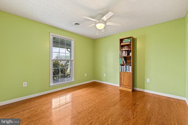 1066 Honeyville Rd, Stanley, VA 22851 - spare room featuring wood finished floors, ceiling fan, baseboards, and a textured ceiling
