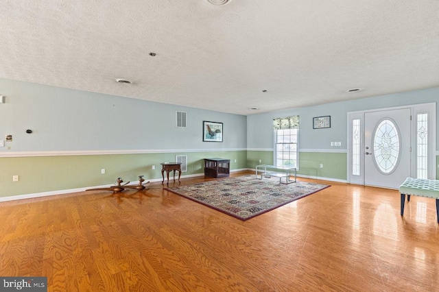 1066 Honeyville Rd, Stanley, VA 22851 - living area featuring a textured ceiling, wood finished floors, and baseboards