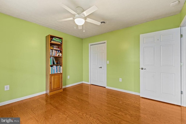 1066 Honeyville Rd, Stanley, VA 22851 - unfurnished bedroom with wood finished floors, baseboards, a textured ceiling, and ceiling fan