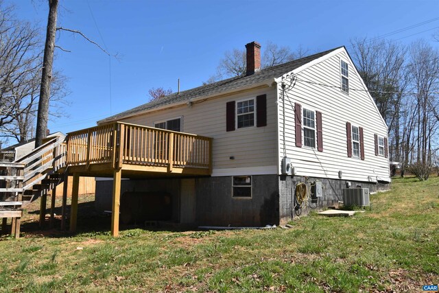 4490 James Madison Hwy, Gordonsville, VA 22942 - back of house with a lawn, a chimney, a wooden deck, and central AC