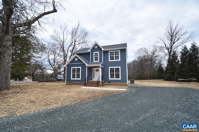 traditional home with roof with shingles, crawl space, and board and batten siding