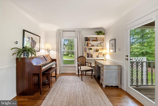  - sitting room featuring crown molding, wood finished floors, and baseboards