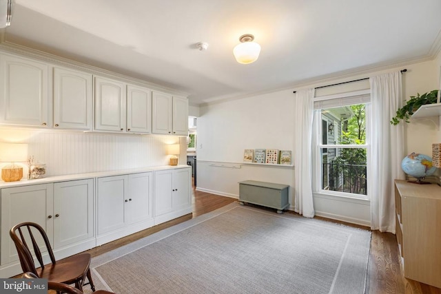  - office space featuring light wood-style flooring, plenty of natural light, ornamental molding, and baseboards