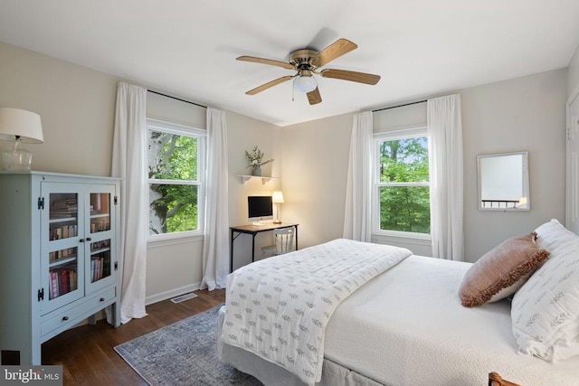  - bedroom featuring dark wood-style floors, baseboards, and ceiling fan
