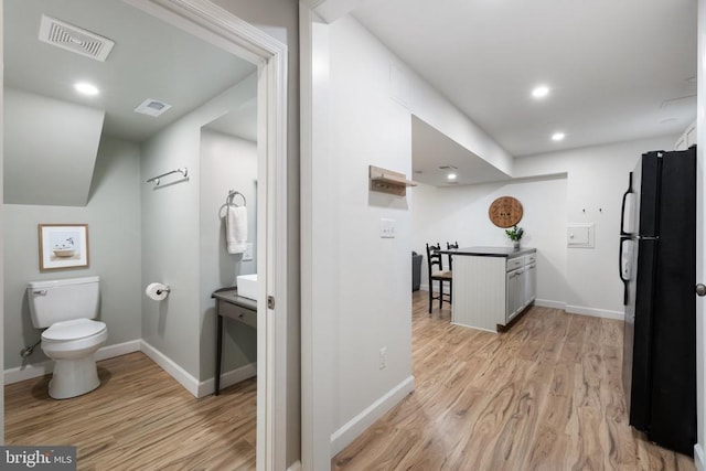  - hall with light wood-style floors, baseboards, and recessed lighting