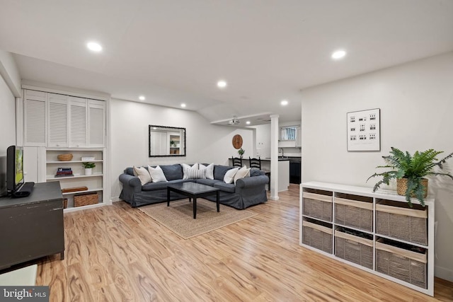 - living area with light wood-style flooring and recessed lighting