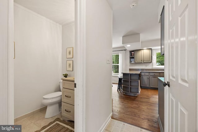  - bathroom featuring vanity, toilet, baseboards, and recessed lighting