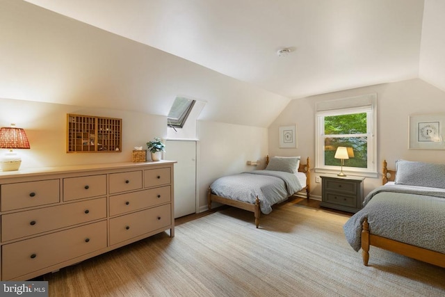  - bedroom with vaulted ceiling and light wood finished floors