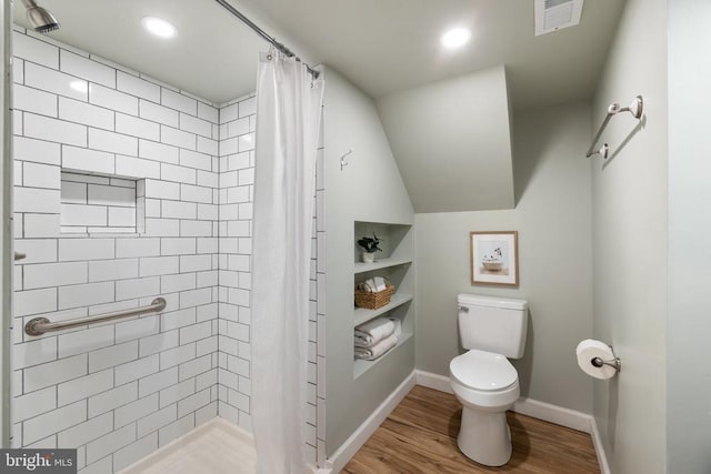  - full bath featuring toilet, wood finished floors, tiled shower, baseboards, and recessed lighting