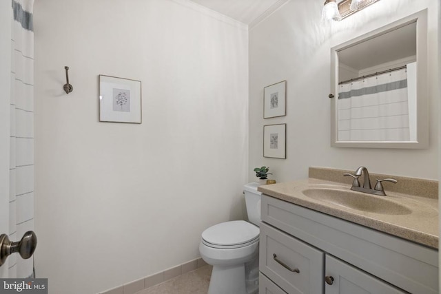  - bathroom featuring toilet, vanity, ornamental molding, and baseboards