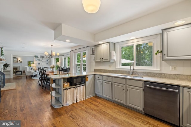  - kitchen with stainless steel dishwasher, gray cabinets, a sink, a peninsula, and open floor plan