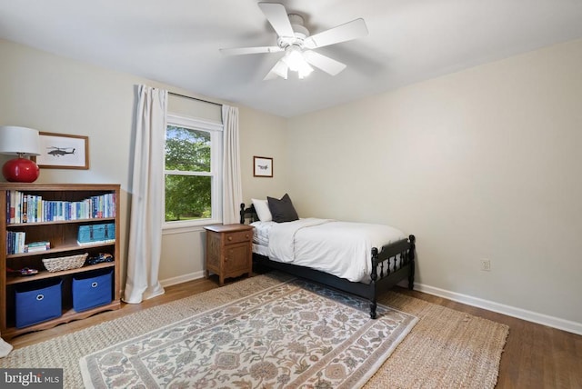  - bedroom with wood finished floors, baseboards, and a ceiling fan