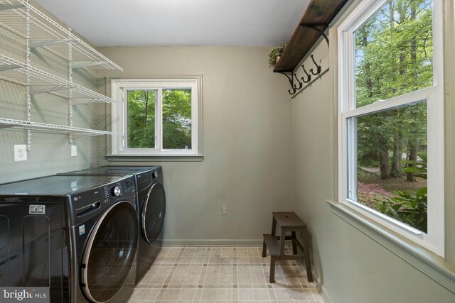  - laundry room featuring washer and dryer and baseboards