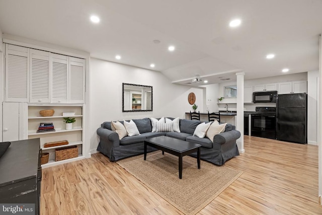  - living room featuring light wood finished floors and recessed lighting